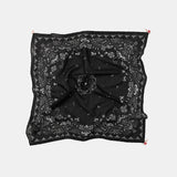 Black patterned scarf with a bow on a white background