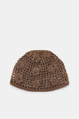 Brown knitted beanie on a light gray background