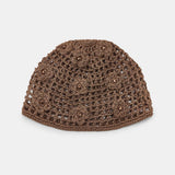 Brown knitted beanie on a light gray background