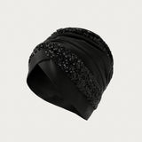 Black strap with metal hooks on a white background