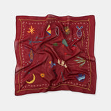 Red scarf with embroidered designs on a white background