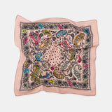 Decorative square scarf with colorful paisley pattern on a light pink background
