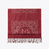 Red scarf with white paisley pattern on a white background