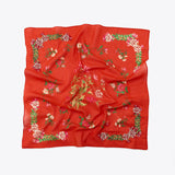 Red scarf with floral patterns on a white background