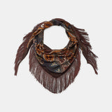 A dark brown patterned scarf with fringe trim, featuring an abstract paisley-like design in shades of brown, black, and gold, displayed on a light gray background.