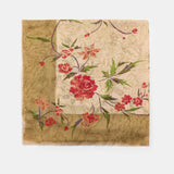 A square scarf with a vintage floral pattern, featuring red and pink flowers, green leaves, and a textured beige background with a gold border, displayed flat against a light gray background.