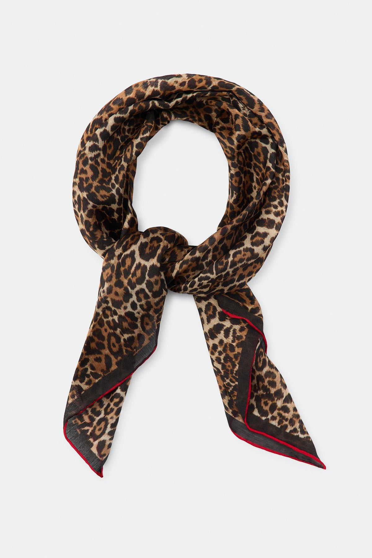 Leopard print scarf with red accents on a white background