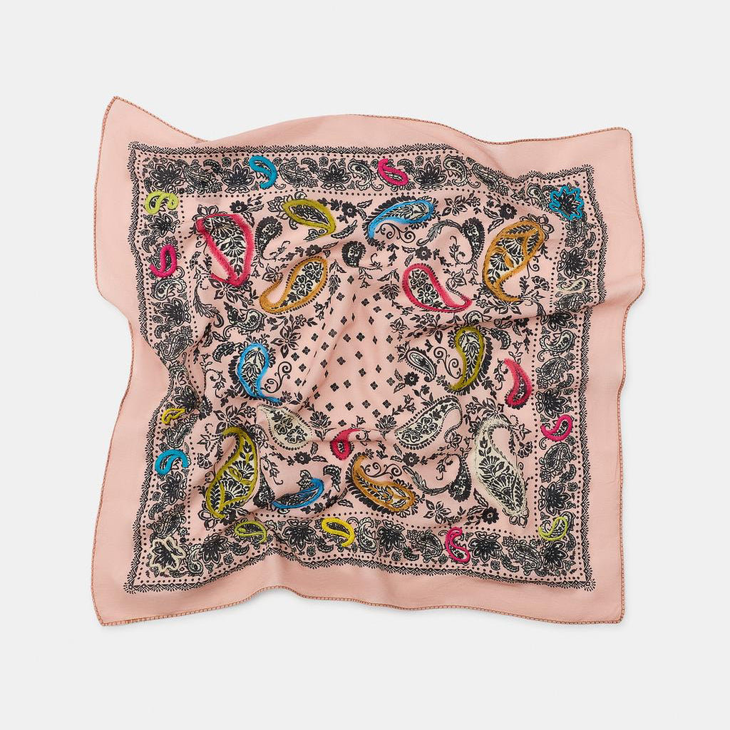 Decorative square scarf with colorful paisley pattern on a light pink background