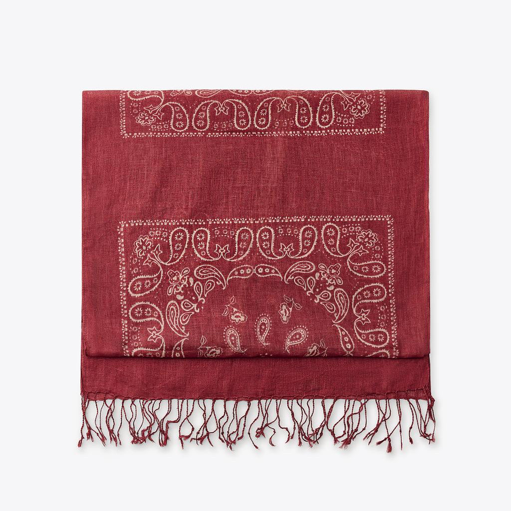 Red scarf with white paisley pattern on a white background