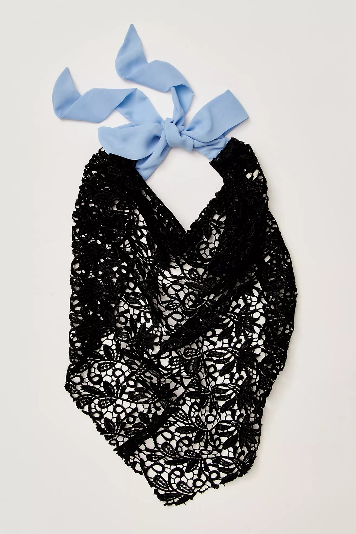 Black lace baby romper with a blue bow on a light gray background