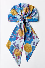 Colorful floral scarf tied in a knot on a white background
