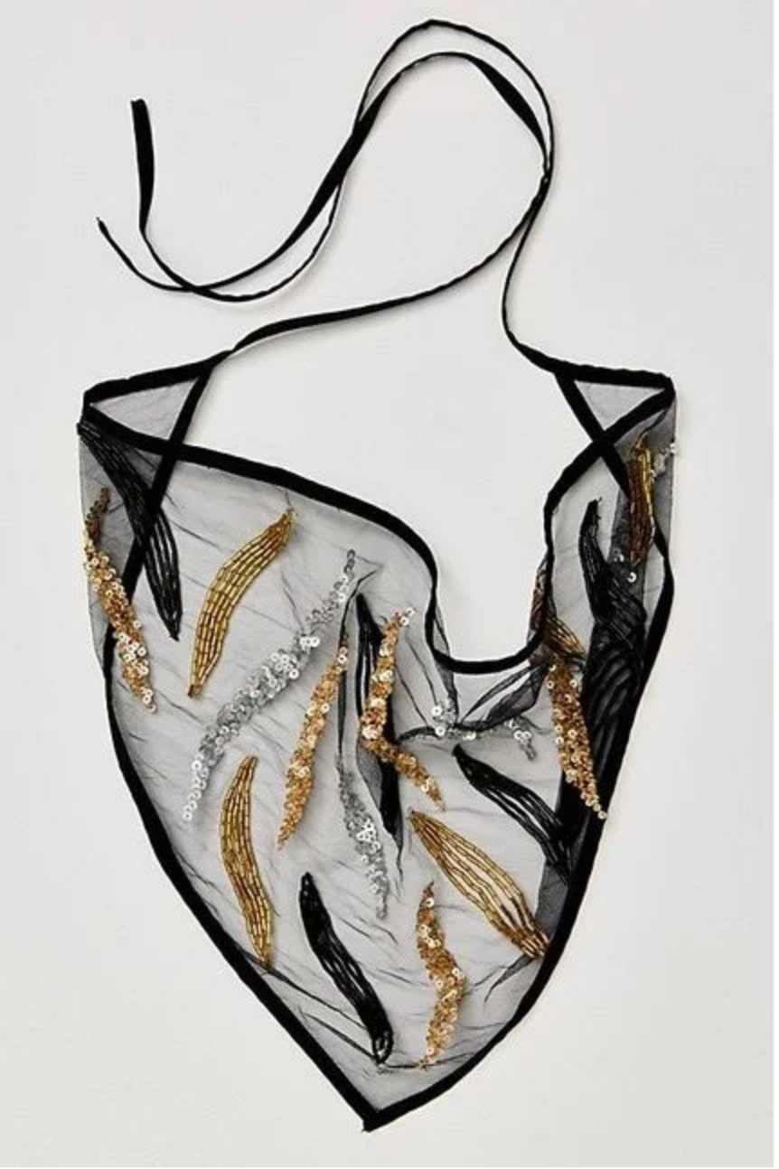 Translucent black bikini top with gold and silver embellishments on a white background