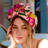 Woman wearing a colorful floral headscarf outdoors