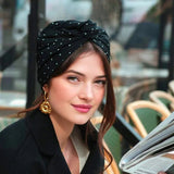 Woman reading a newspaper in a cafe setting